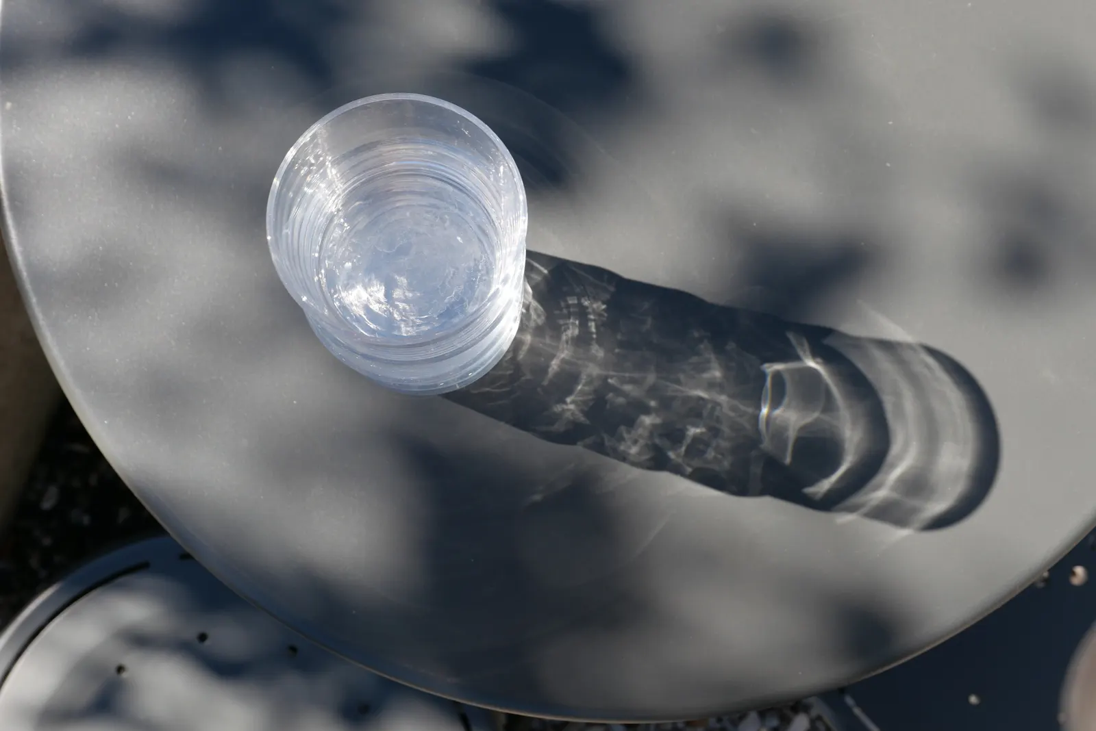 Drinking glass on a table in sunlight
